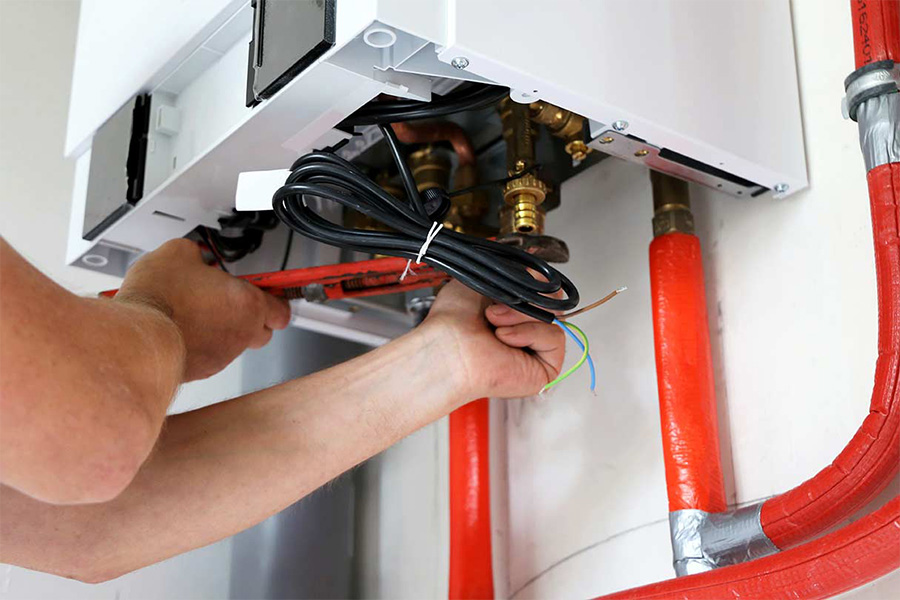 man repairing residential heating system